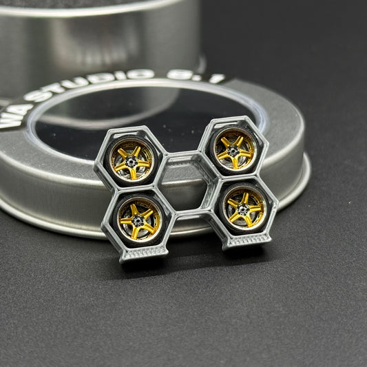 Metal model wheel with four yellow hex hub discs and silver rim