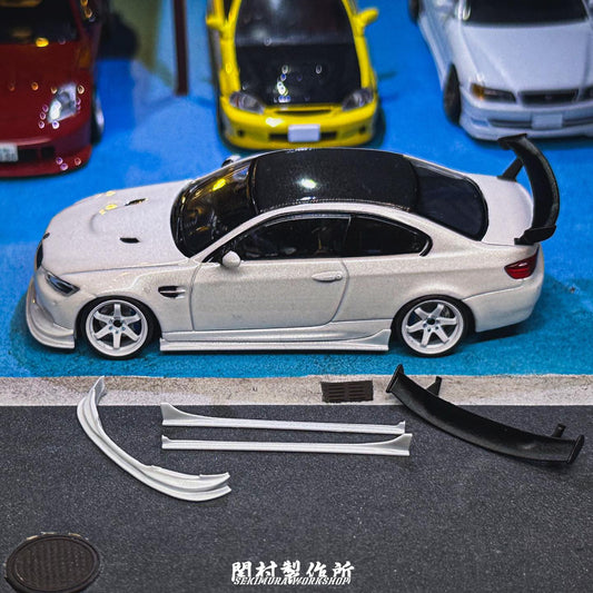 White assist-style bodykit parts displayed: front splitter and side skirts