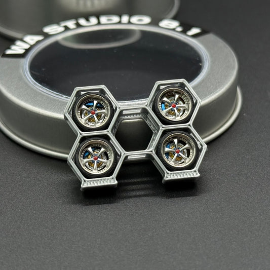Silver wheel hub with hexagonal lug openings and multicolor center caps