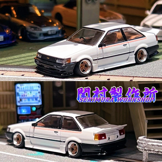 White Toyota LEVIN AE86 bodykit model car with black grille, front lip, and bronze wheels