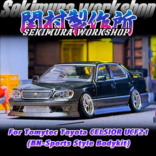 Dark model sedan with front sport bumper, chrome grille, and lowered wheels
