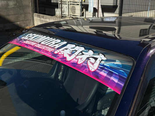 Purple-blue windshield banner with Sekimura Collective lettering