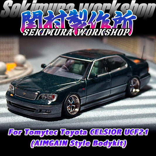 Dark green die-cast sedan model with aftermarket body kit, front three-quarter view