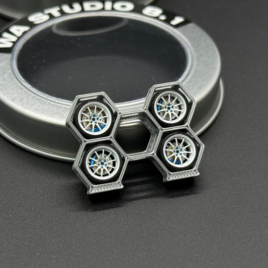 Four miniature alloy wheels with blue hubs in hex chrome frame