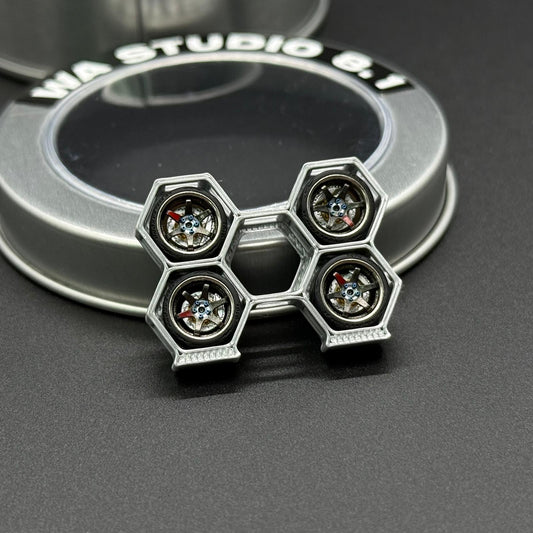 Silver wheel cap with hex spoke pattern and four circular jewel accents