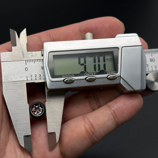 1/64 TE37 wheel size measurement with caliper; silver rim and hex star center