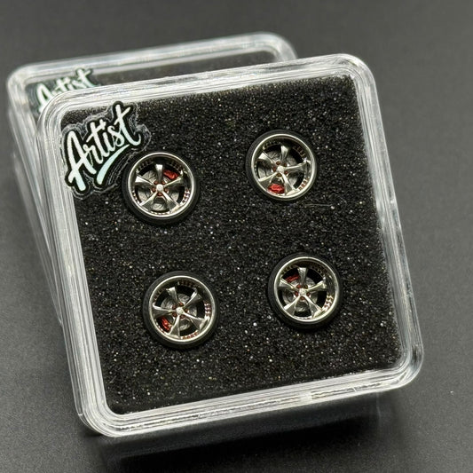 Set of four small metal model wheels with chrome rims in clear display case