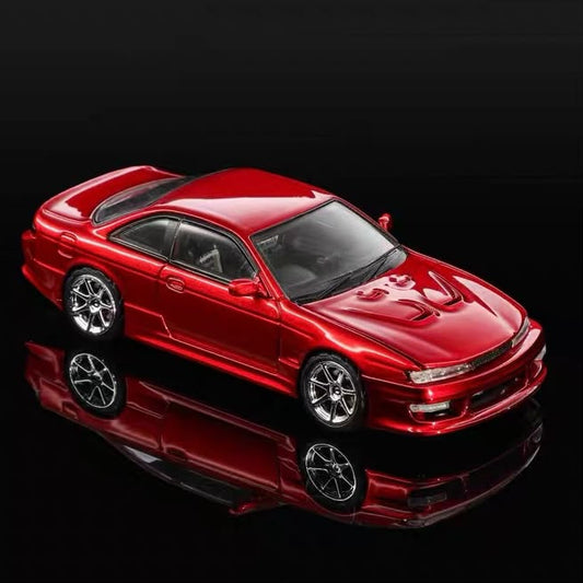 Red 1/64 scale Silvia S14 diecast coupe model, front three-quarter view