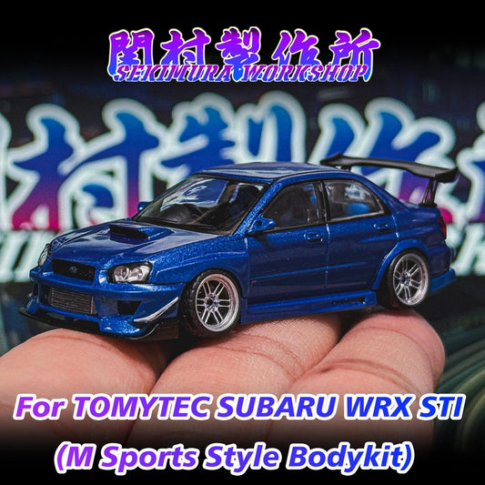 Blue SUBARU WRX STI model car with M-sports bodykit, held in hand, front view