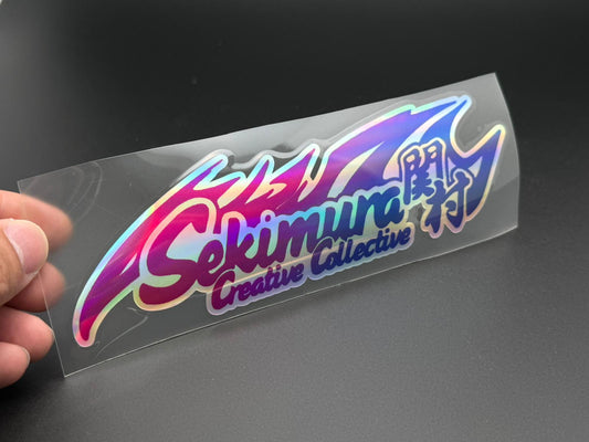 SekimuraCCC Creative Collection sticker with purple blue rainbow logo and script text