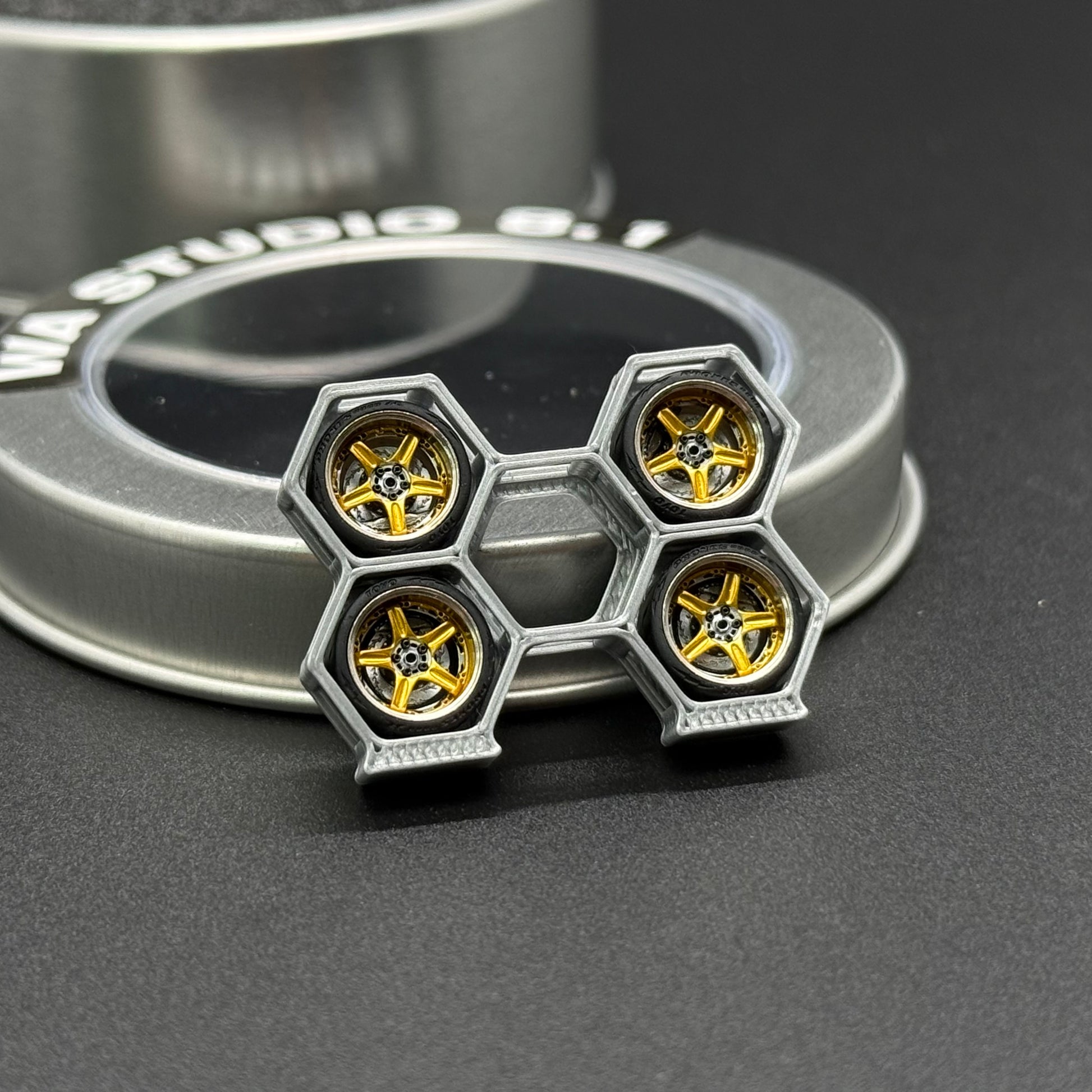 Metal model wheel with four yellow hex hub discs and silver rim