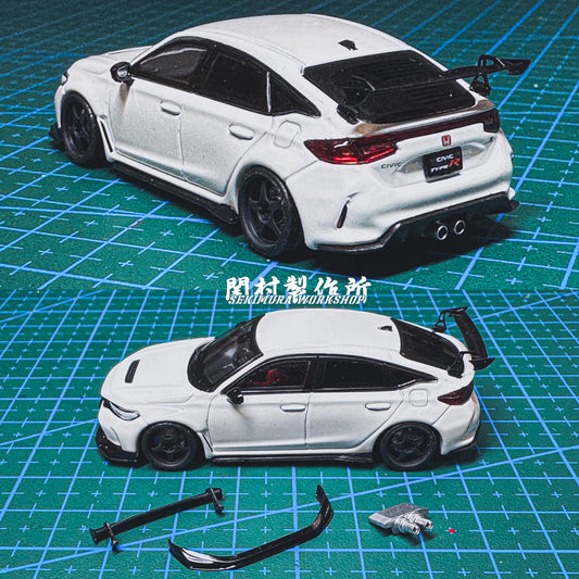 White sport car model kit on green cutting mat with curved parts and pieces