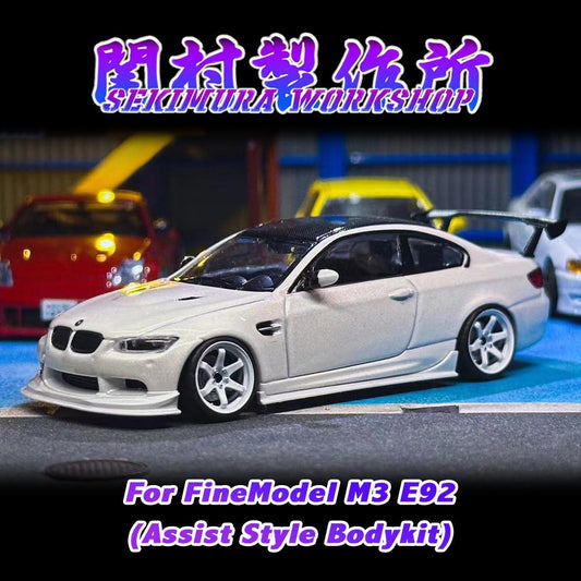 White assist-style bodykit on model coupe, front lip and side skirts