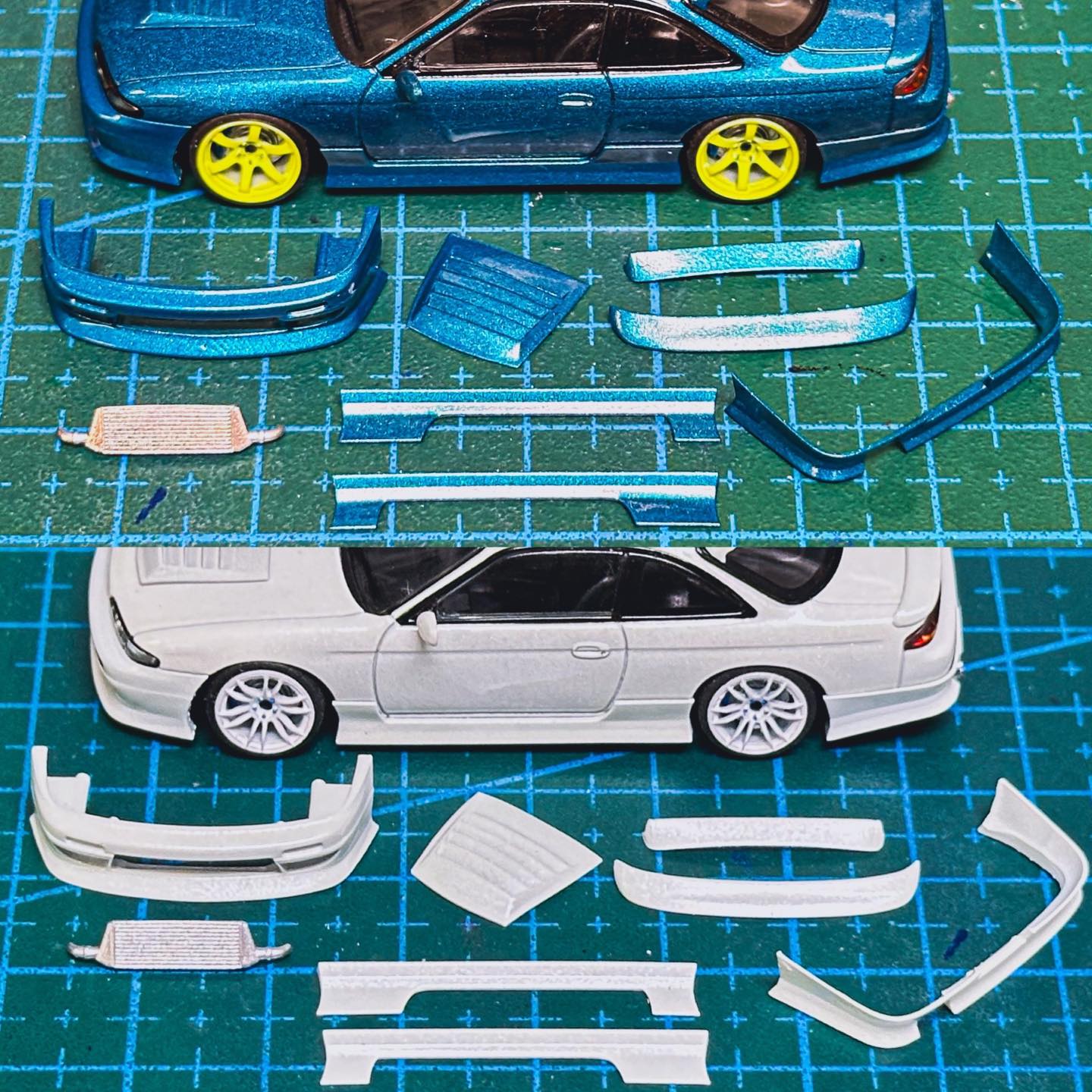Assorted sports car body kit parts in blue and white, laid out