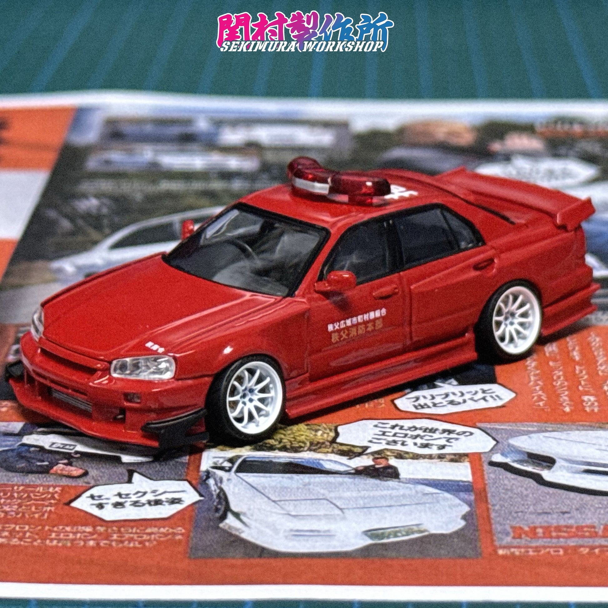 Red die-cast car model with hood scoop, front bumper, and white wheels