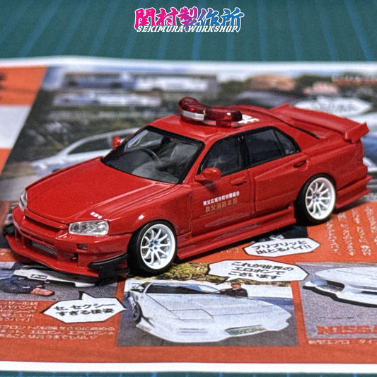 Red die-cast car model with hood scoop, front bumper, and white wheels