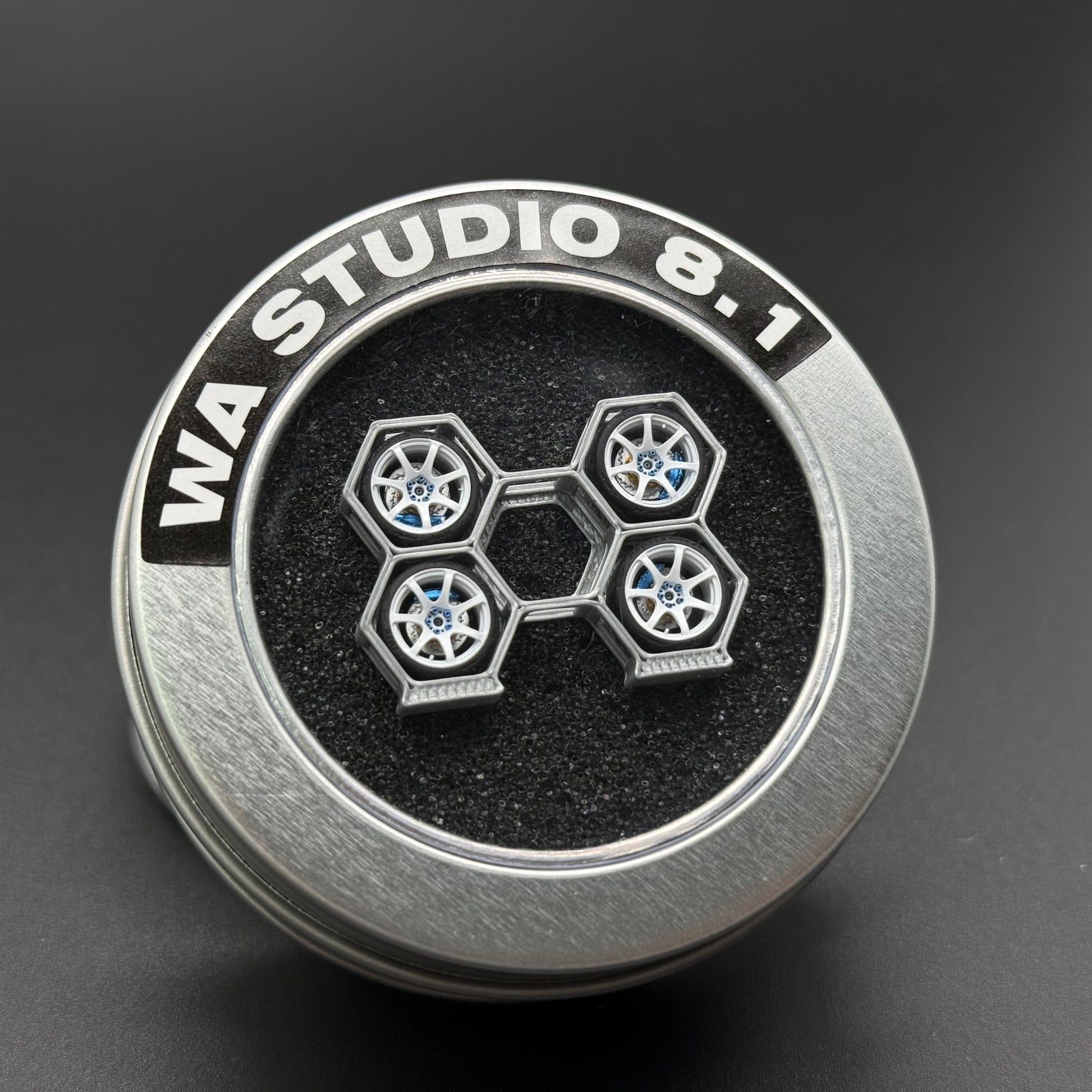 WA Studio hubcap with hex wheel emblem and five-spoke rims, silver and black