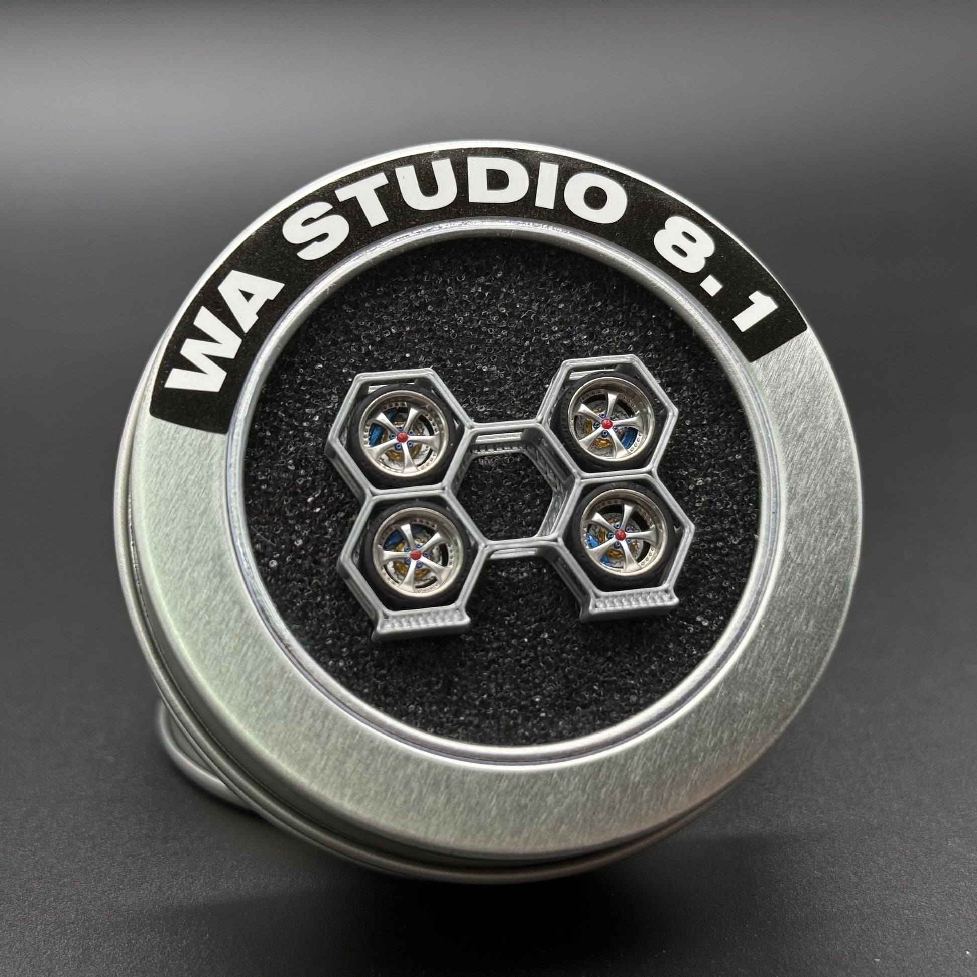 Metallic silver die-cast wheels hub with 'WA STUDIO' marking and five lug spokes