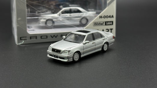 Silver die-cast sedan model, front view with grille, hood scoop, and headlamps