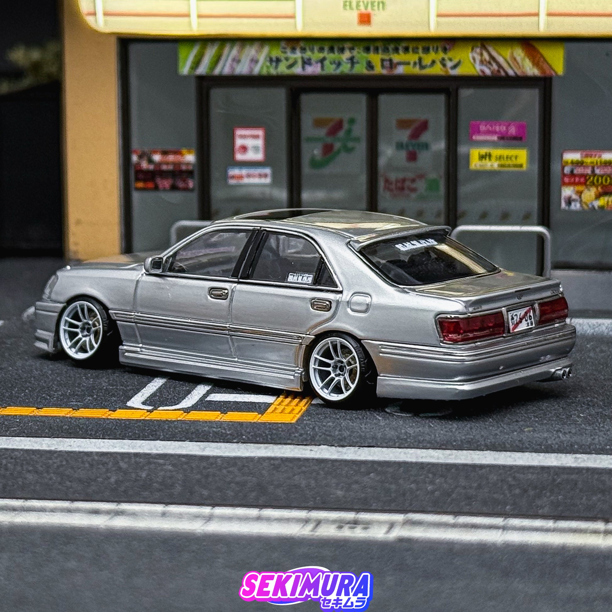 Silver die-cast-style sedan rear view with side skirts and bodykit rear bumper