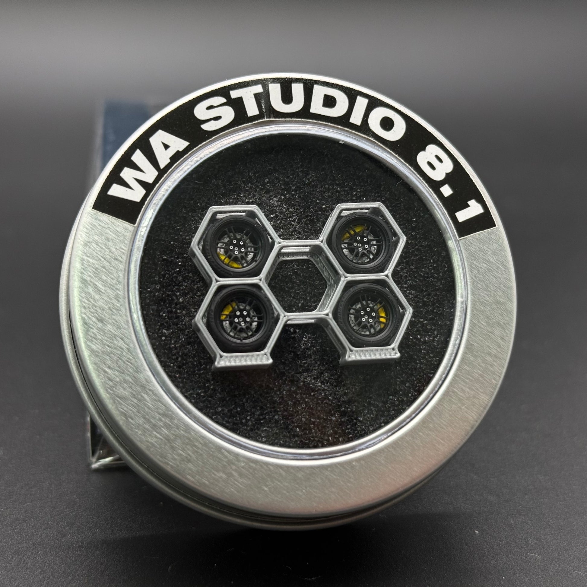 WA STUDIO 1/64 wheel, black hex pattern hub with metallic rim, front close-up