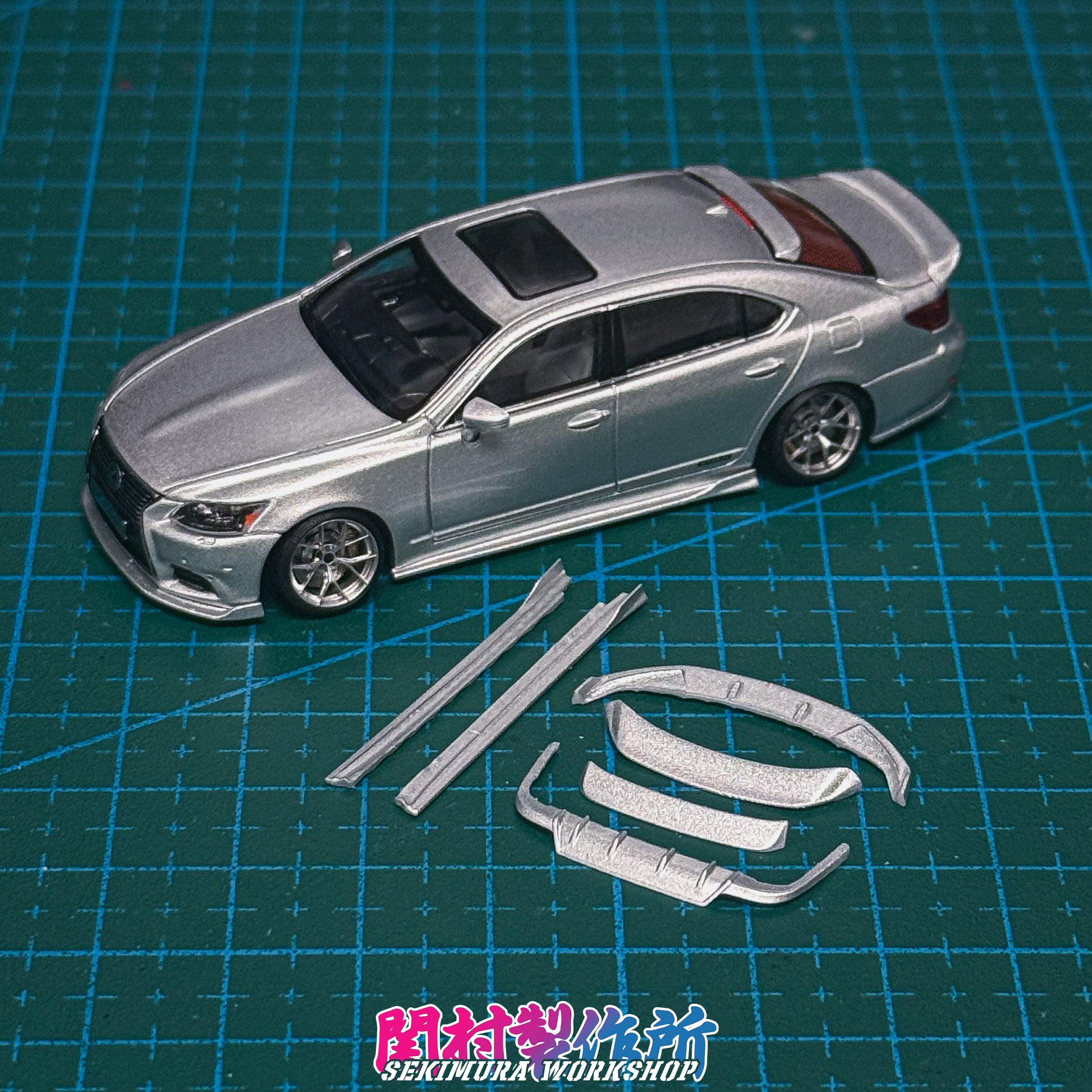 LS600hL body kit parts with assembled silver sedan model on a cutting mat