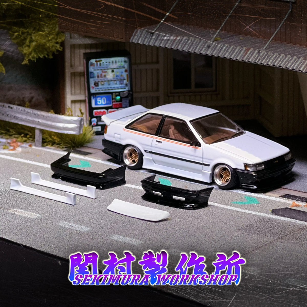 White Toyota LEVIN AE86 bodykit model car on road with black split front aero