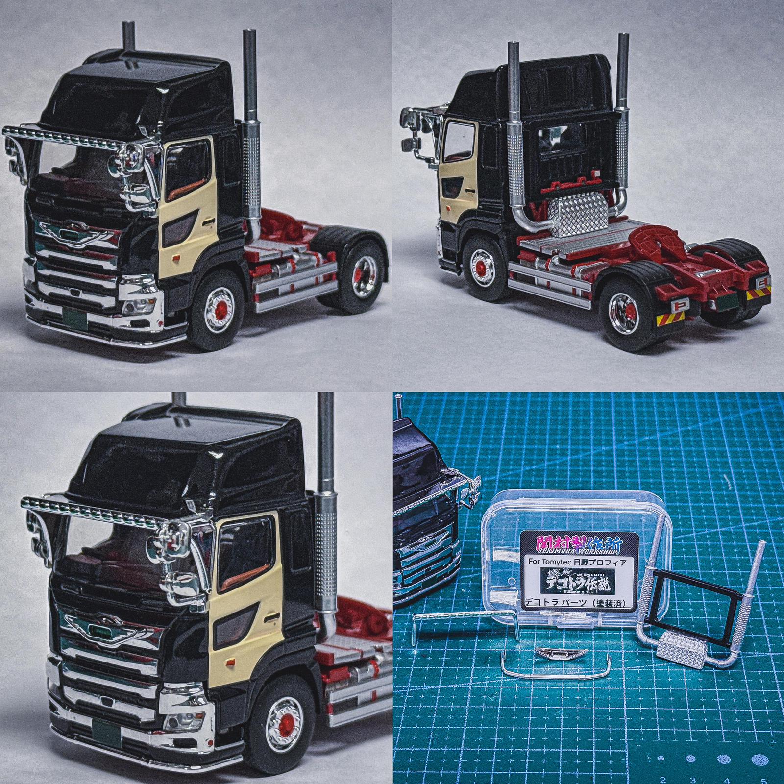 Model semi truck cab in black and cream with red chassis and mounted parts