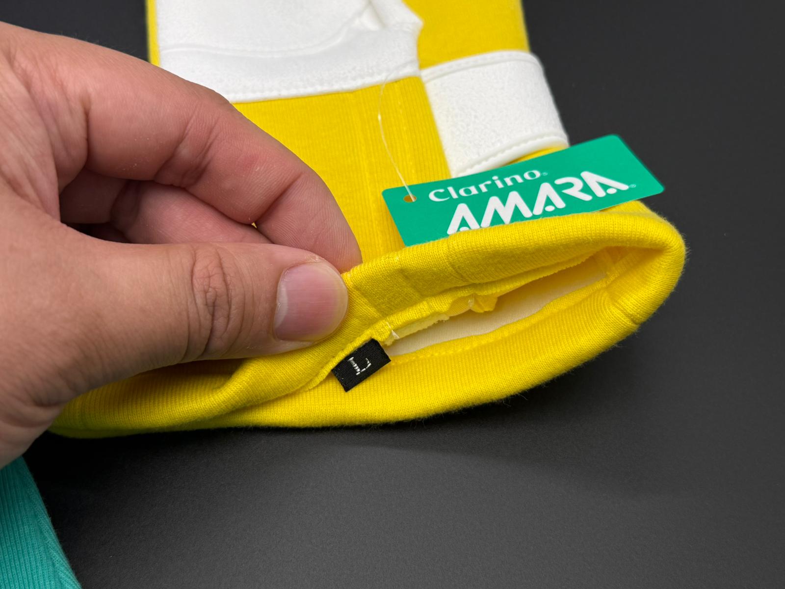 Racing glove cuff detail with AMARA label and size L tag on yellow