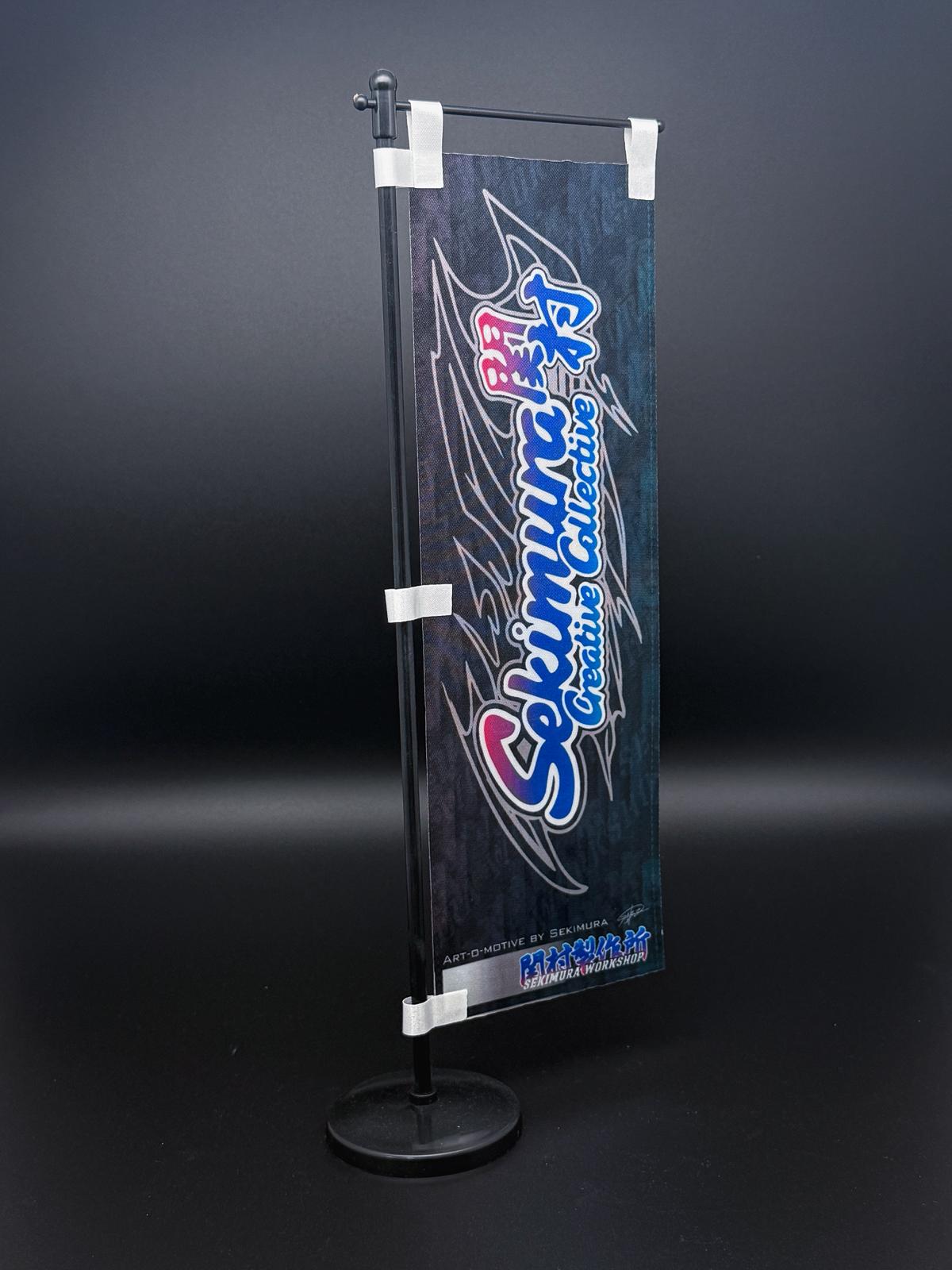 Sekimura mini nobori flag on stand, dark banner with blue and pink logo text