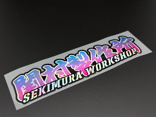 Sekimura Workshop sticker 23x5cm, blue and pink lettering on white backing