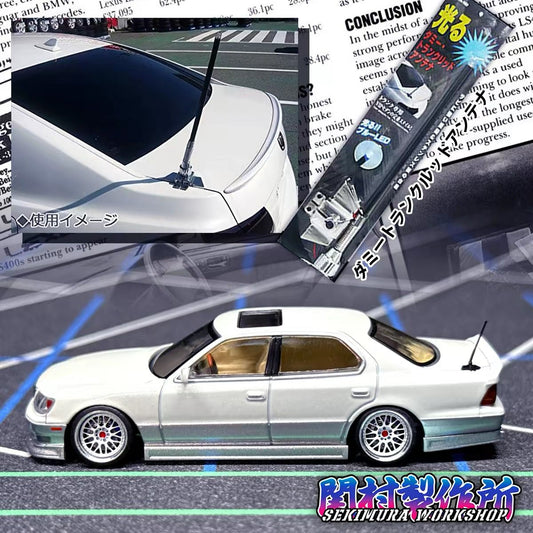 White 1/64 scale VIP style model car with roof antenna and front view
