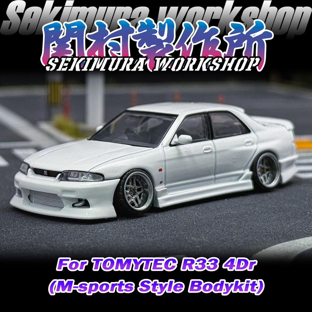 White car model with aftermarket front bumper, headlights and wheels clearly shown
