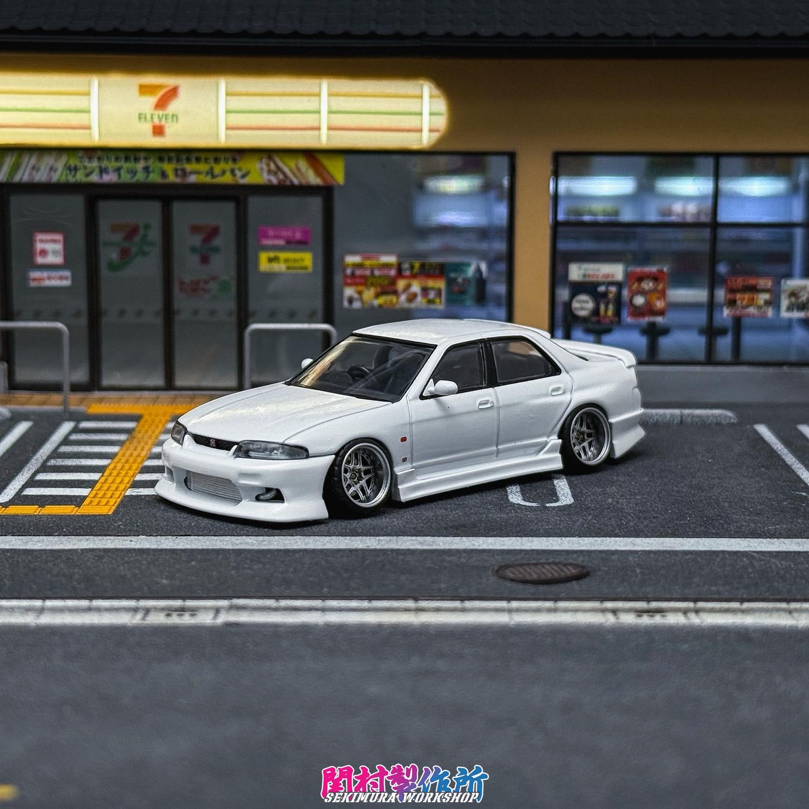 White modified car model with front bumper and hood lines, low stance