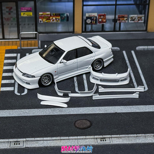 White modified Nissan-style car with front lip and side skirts on display