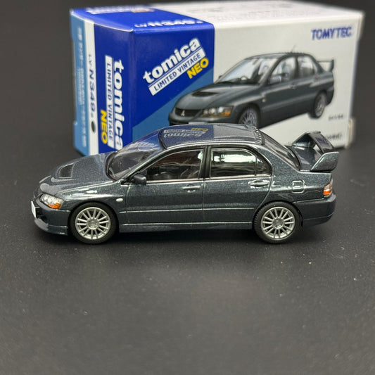 Dark gray die-cast car model shown in side view with open hood