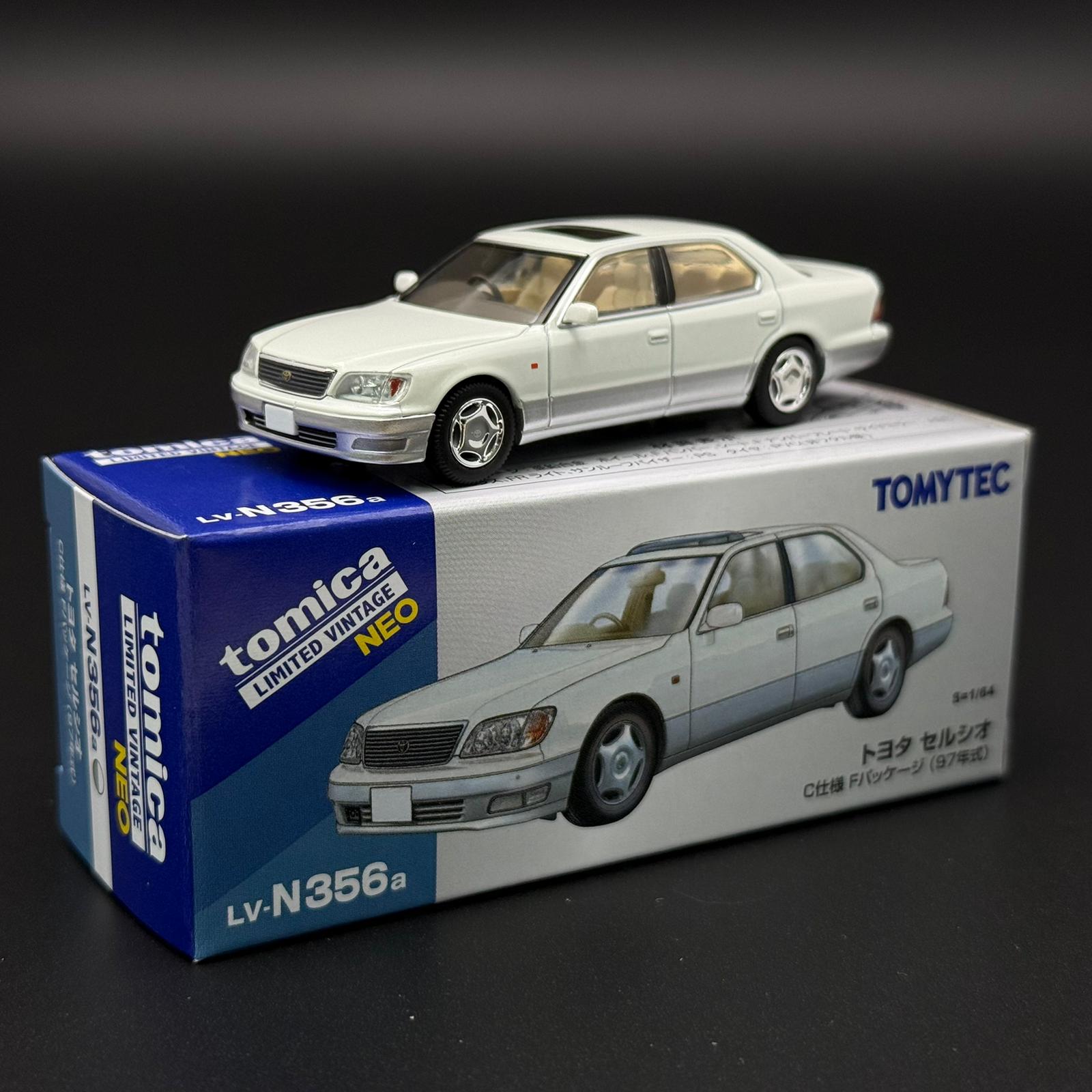 White two-door die-cast car model with front grille and silver wheels on display box