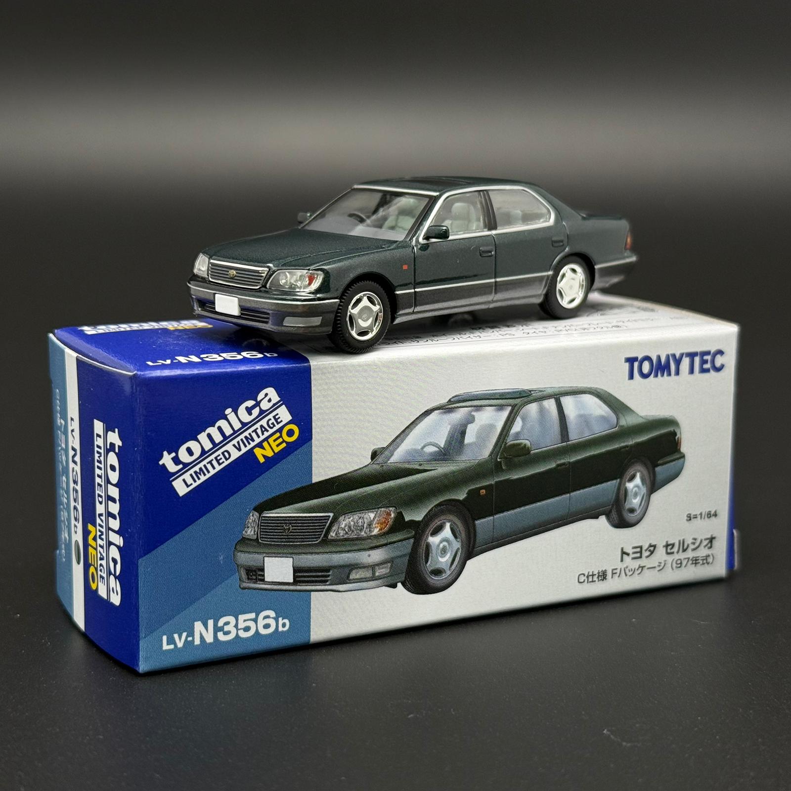 Green two-door die-cast car model with front grille and silver wheels on display box