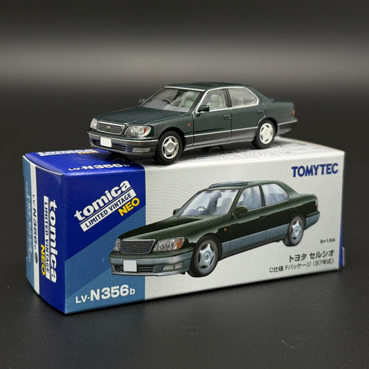 Green two-door die-cast car model with front grille and silver wheels on display box