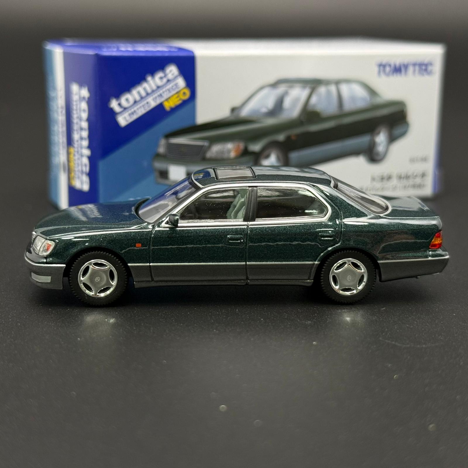 Green two-door die-cast car model in side profile with silver wheels and hood scoop