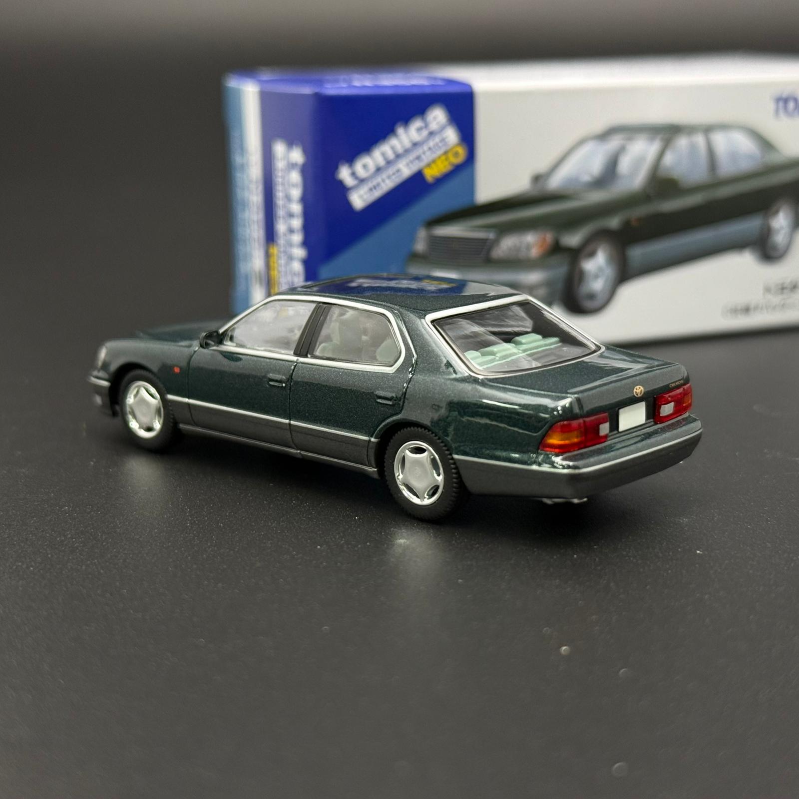 Green two-door die-cast car model with rear lights and silver wheels, angled view