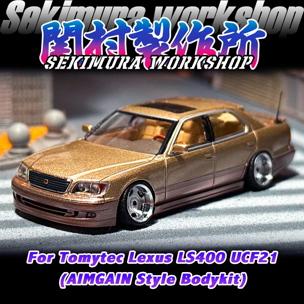 Two-tone gold die-cast sedan model with aftermarket body kit, front three-quarter view