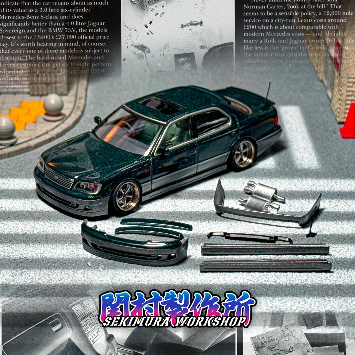 Dark green die-cast sedan with aftermarket body kit parts, front view and components