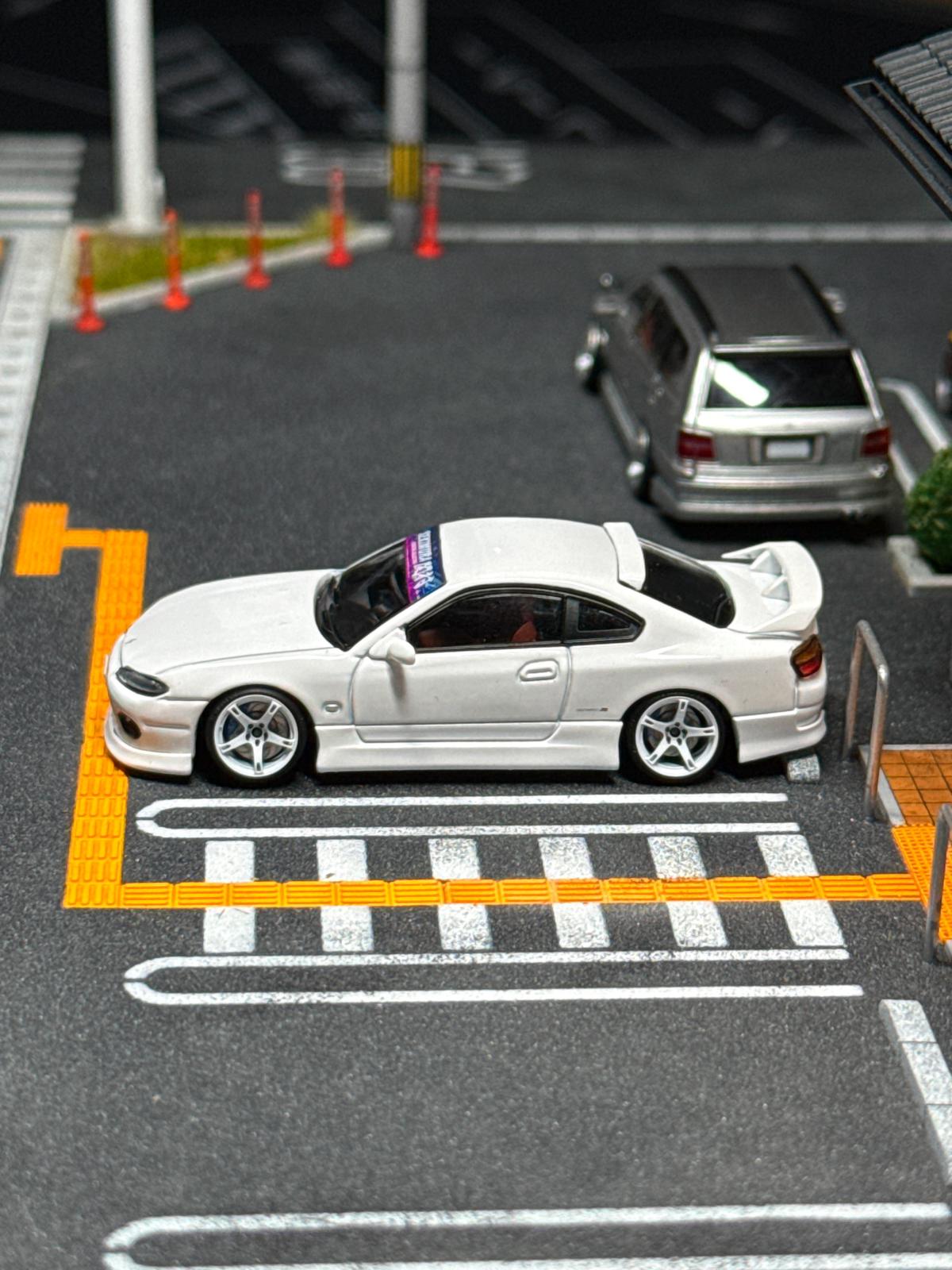 White sports car bodykit model viewed from rear, with wheels and exhaust