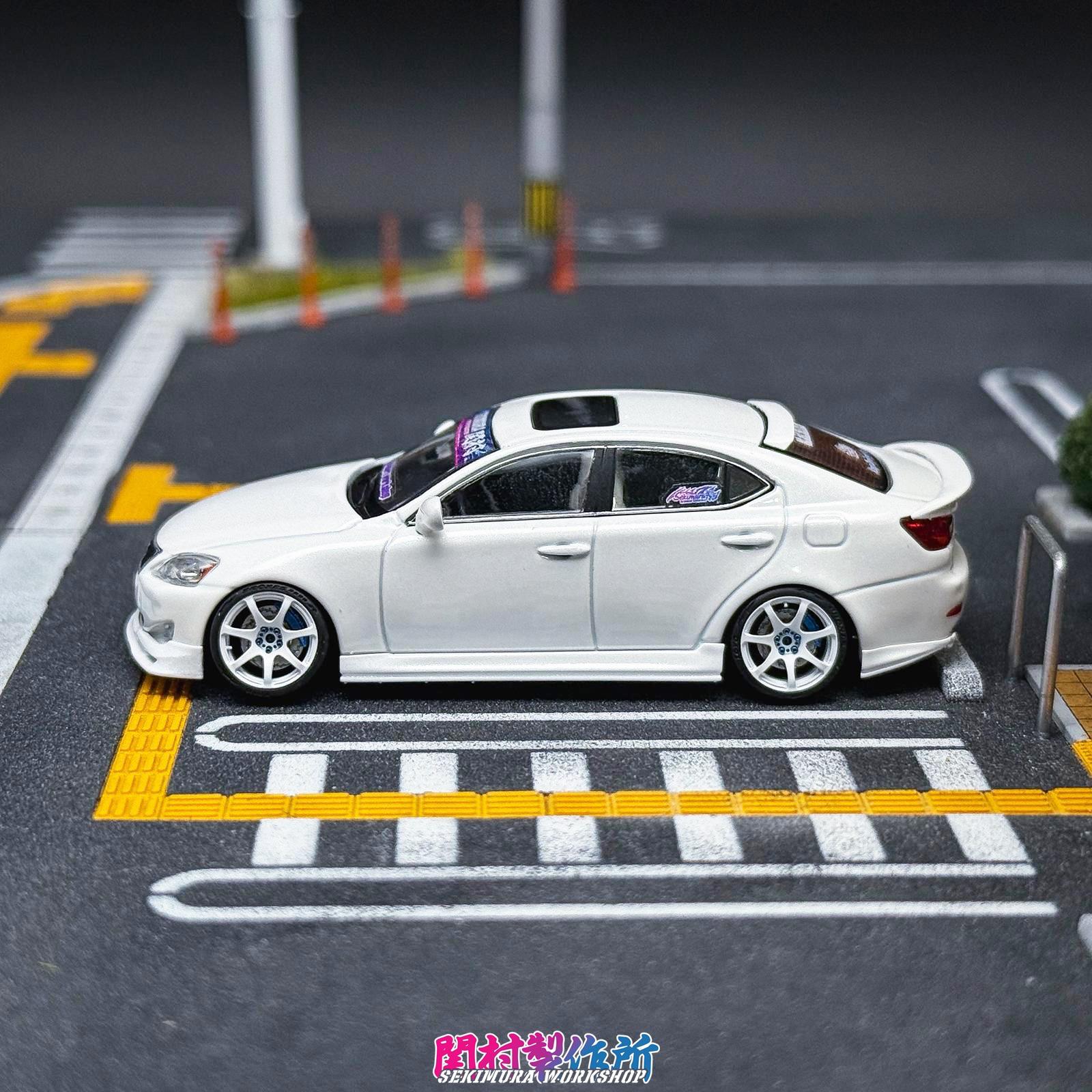 White Lexus IS350-style bodykit car with side skirts and rear spoiler, side view