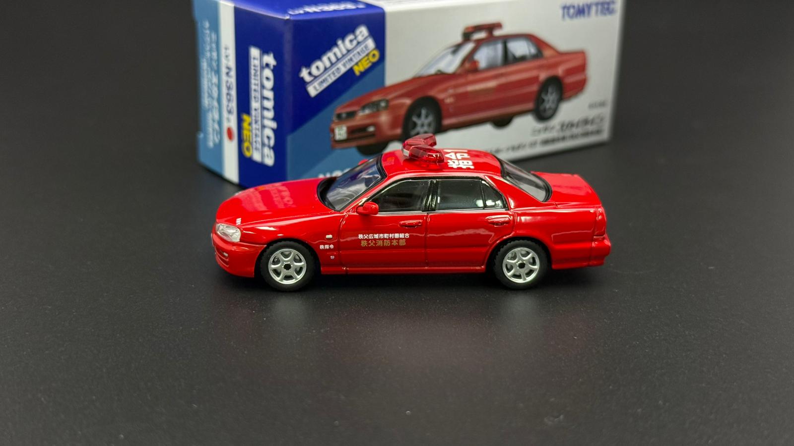 Tomytec 1/64 ER34 4-Door red model car, side view with display box