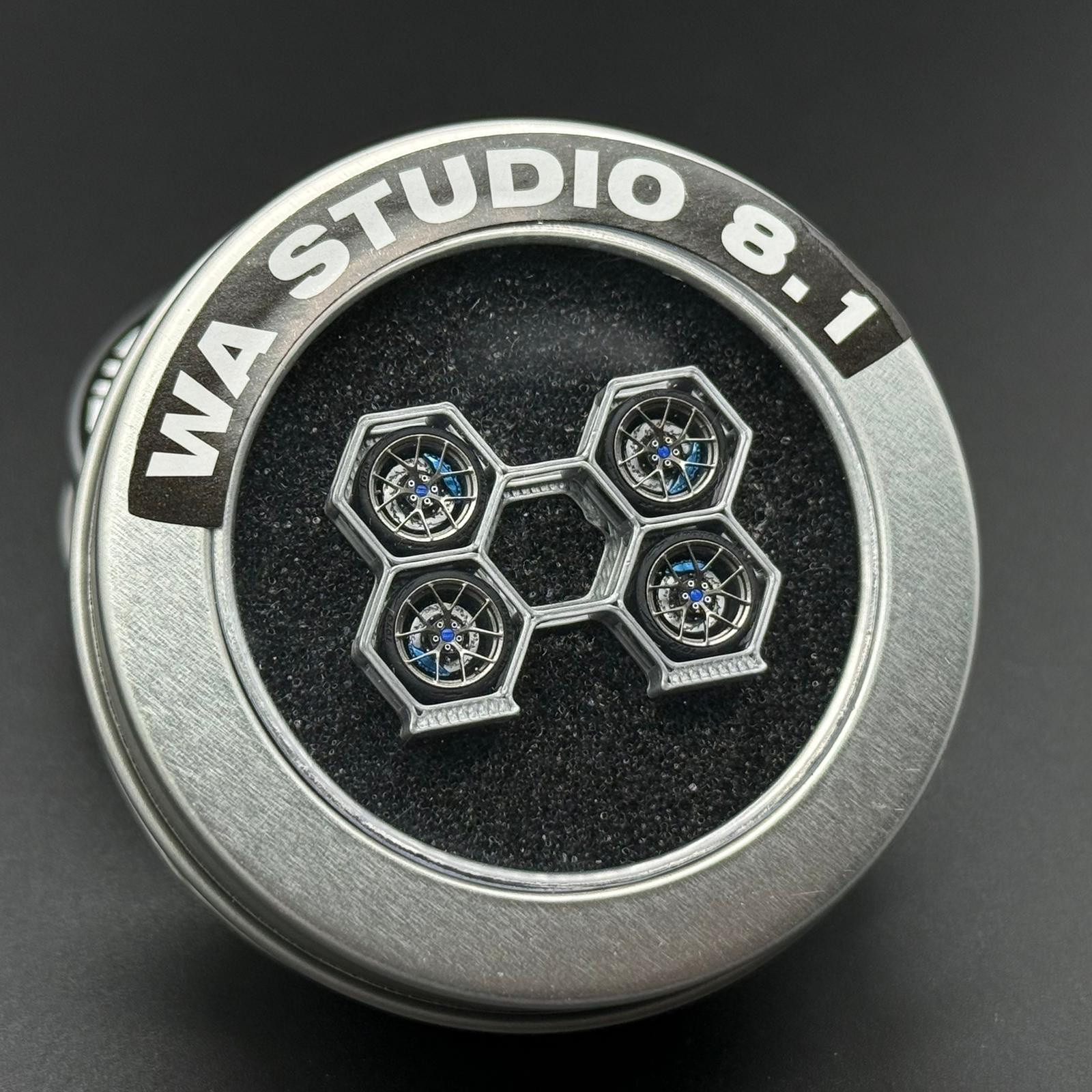 Scale model wheel with WA STUDIO branding, silver hex-spoke design and blue hub accents