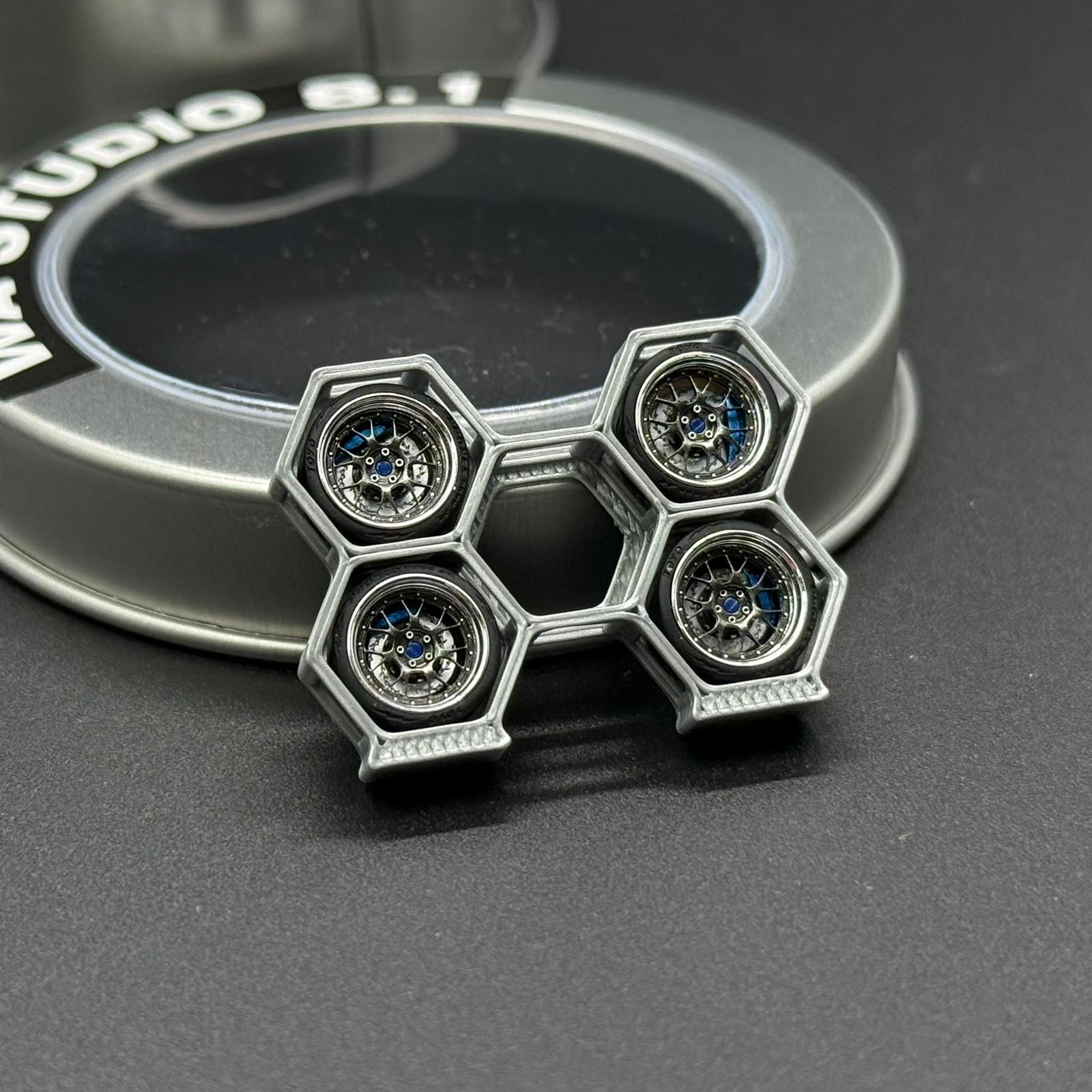 Metal wheel center cap with five hex bolt details and blue accents