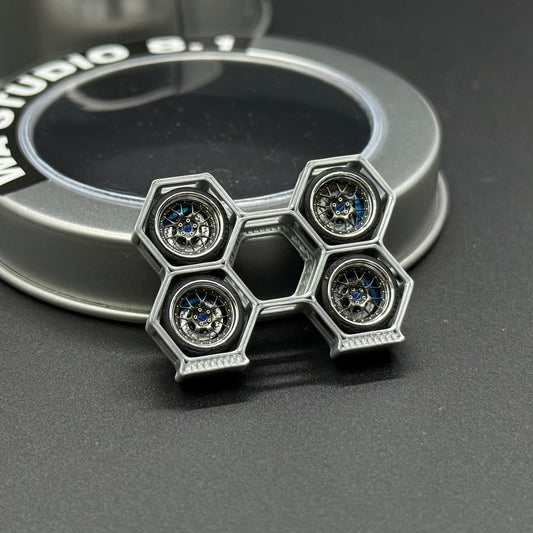 Metal wheel center cap with five hex bolt details and blue accents
