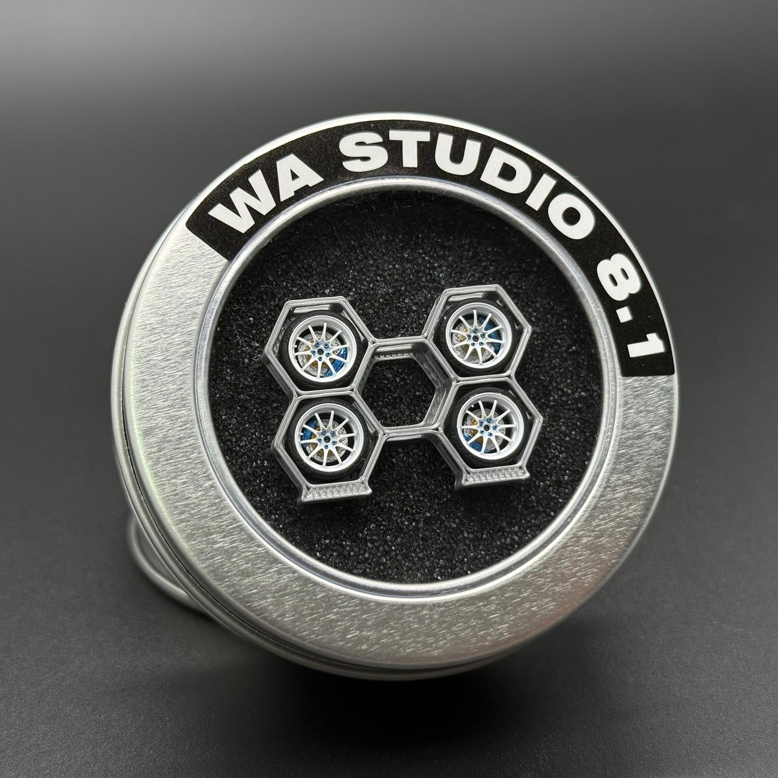Four-spoke wheel set in round case labeled WA STUDIO